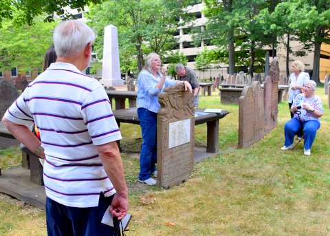 Group viewing gravestones at the burial ground